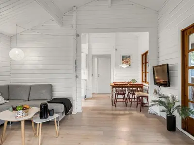 a living room with a couch and a table at Holiday Home Tammo - 1-1km from the sea by Interhome in Blokhus