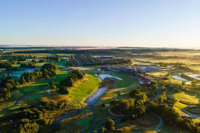 an aerial view of a golf course with water at Skønt Sommerhus Golfhytte midt i skønne omgivelser in Gatten