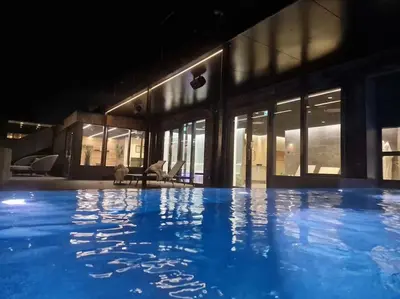 a large swimming pool in front of a building at Skønt Sommerhus Golfhytte midt i skønne omgivelser in Gatten