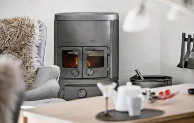 a living room with a stove in a kitchen at Lovely Home In Blokhus With Wifi in Blokhus