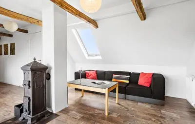 a living room with a black couch and a table at 4 Bedroom Gorgeous Home In Vestervig in Vestervig