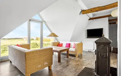 a living room with a couch and a table at 4 Bedroom Gorgeous Home In Vestervig in Vestervig