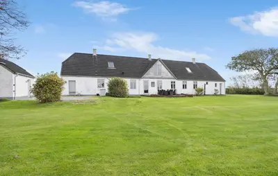 a large white house with a large green yard at 4 Bedroom Gorgeous Home In Vestervig in Vestervig
