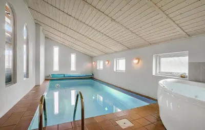 a large swimming pool with a tub and a bath tub at Pet Friendly Home In Thisted With Sauna in Thisted