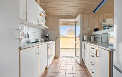 a kitchen with white cabinets and an open door at Pet Friendly Home In Thisted With Sauna in Thisted