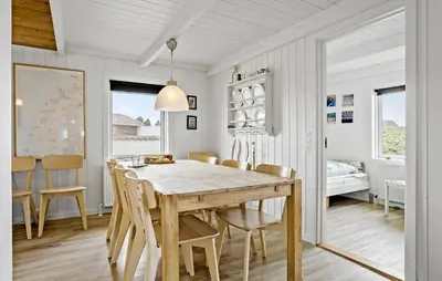 a dining room with a wooden table and chairs at Awesome Home In Thisted With Sauna in Thisted