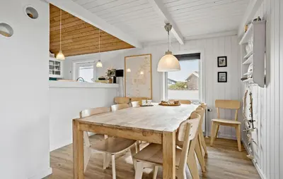 a dining room with a wooden table and chairs at Awesome Home In Thisted With Sauna in Thisted