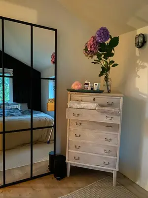 a bedroom with a dresser and a mirror at En SMUK og CHARMERENDE OASE meget tæt på centrum! in Holstebro