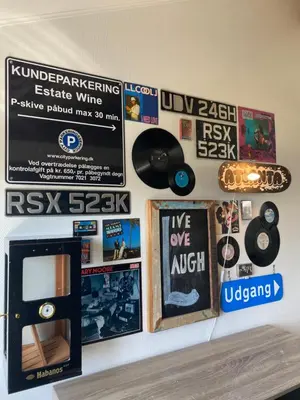 a wall with posters and a skateboard on it at En SMUK og CHARMERENDE OASE meget tæt på centrum! in Holstebro