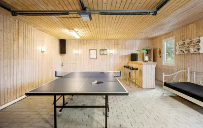 a ping pong table in the middle of a room at Gorgeous Home In Blokhus With Sauna in Blokhus