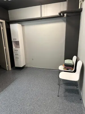 a room with a garage with a chair and a closet at Struer Festcenter - Vest Bowl lejlighed 1 Bredgade 62 C in Struer