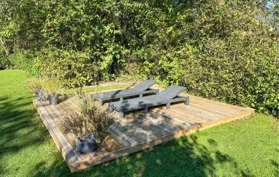 a group of benches sitting on a wooden deck at Awesome Home In Hjerm With Wifi in Hjerm