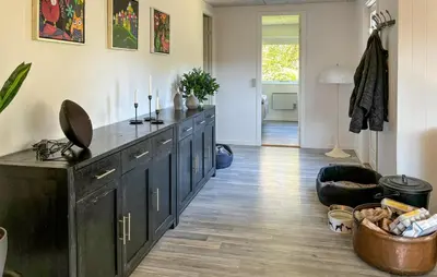 a kitchen with black cabinets and a wooden floor at Awesome Home In Hjerm With Wifi in Hjerm