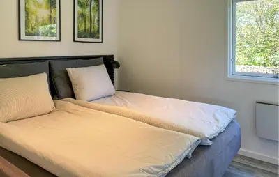 a bed in a room with two pillows on it at Awesome Home In Hjerm With Wifi in Hjerm