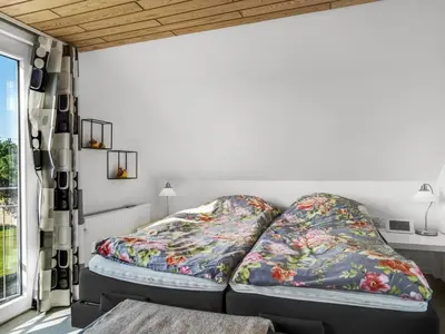 a bedroom with two beds and a window at Holiday Home Isabel - 600m from the sea by Interhome in Blokhus