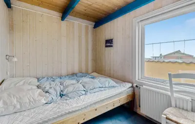 a bed in a room with a window at Beautiful Home In Thisted With Sauna in Thisted