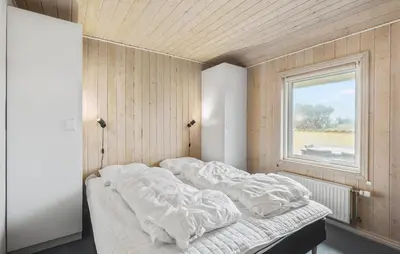 a bed in a room with a window at Beautiful Home In Thisted With Sauna in Thisted