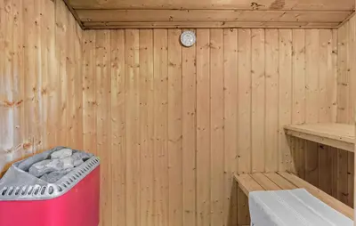 a inside of a wooden sauna with a trash can at Beautiful Home In Thisted With Sauna in Thisted