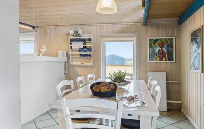 a dining room with a white table and chairs at Beautiful Home In Thisted With Sauna in Thisted