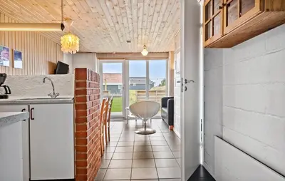 a kitchen with a brick wall and a table at 2 Bedroom Cozy Home In Thisted in Thisted