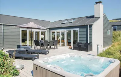 a hot tub on a deck with a patio at Five-Bedroom Holiday Home Løkken With A Room Hot Tub 04 in Løkken