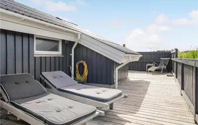 a patio with two beds on a wooden deck at Three-Bedroom Holiday Home Harboøre With A Fireplace 06 in Harboør
