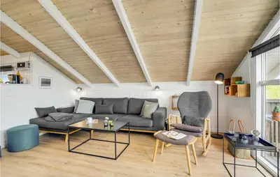 a living room with a couch and a table at Three-Bedroom Holiday Home Harboøre With A Fireplace 06 in Harboør