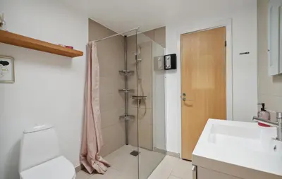 a bathroom with a shower and a toilet and a sink at Three-Bedroom Holiday Home Thyholm With A Fireplace 06 in Thyholm