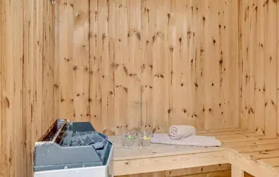 a wooden room with a table with wine glasses at Three-Bedroom Holiday Home Thyholm With A Fireplace 06 in Thyholm