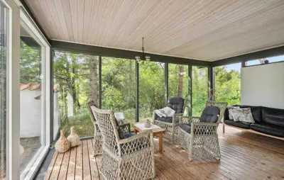 a screened in porch with chairs and a screen at Three-Bedroom Holiday Home Thyholm With A Fireplace 06 in Thyholm