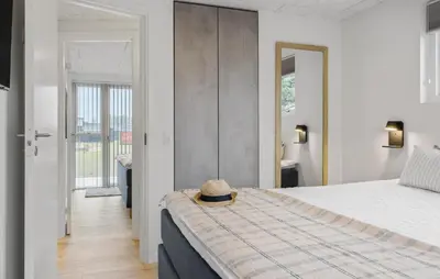 a bedroom with a bed with a hat on it at Cozy Home In Saltum With Sauna in Saltum