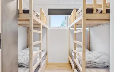 a room with two bunk beds and a window at Cozy Home In Saltum With Sauna in Saltum