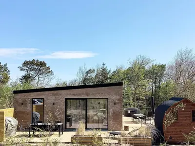 a brick house with glass doors and a patio at 5 star holiday home in Vestervig-By Traum in Vestervig