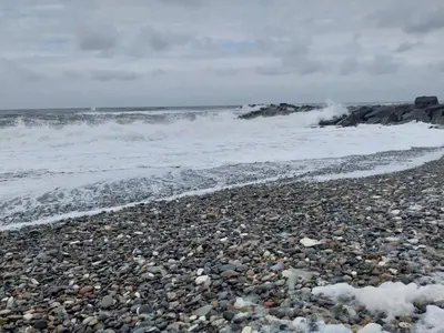 a rocky beach with waves and the ocean at 5 star holiday home in Vestervig-By Traum in Vestervig