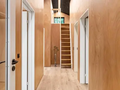 a hallway with wooden walls and a staircase in a house at 5 star holiday home in Skals in Skals