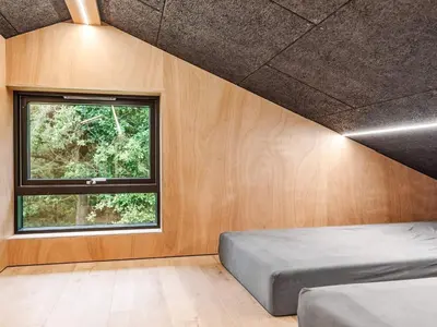 a bedroom with a bed and a window at 5 star holiday home in Skals in Skals