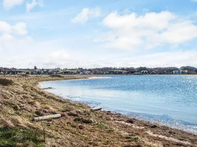 a view of a body of water with buildings in the background at 5 star holiday home in Højslev in Højslev