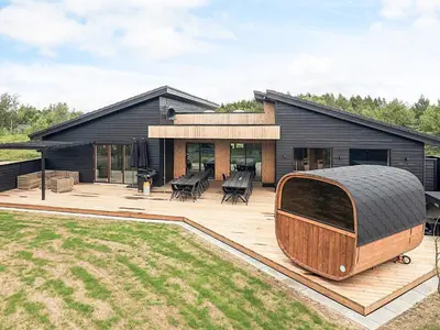 a house with a large deck with a boat on it at 5 star holiday home in Højslev in Højslev