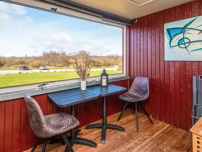 a table and two chairs in a room with a large window at 4 person holiday home in Lemvig in Lemvig