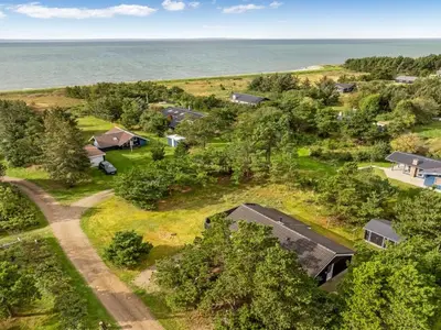 an aerial view of a farm with houses and the ocean at Holiday Home Skrollan - 200m to the fjord by Interhome in Sindrup