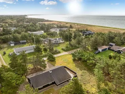 an aerial view of a home with the ocean in the background at Holiday Home Skrollan - 200m to the fjord by Interhome in Sindrup