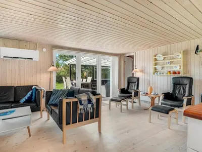 a living room with a couch and chairs at Holiday Home Rajna - 500m to the fjord by Interhome in Vestervig