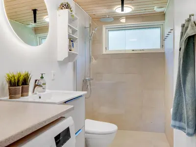 a bathroom with a toilet and a sink at Holiday Home Rajna - 500m to the fjord by Interhome in Vestervig