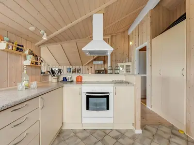 a kitchen with white cabinets and a stove at Holiday Home Märta - 250m from the sea by Interhome in Lemvig