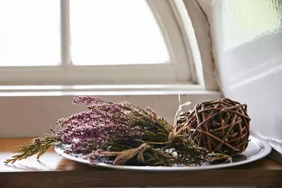 a plate of flowers on a table next to a window at Danhostel Rebild in Skorping