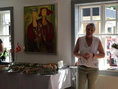 a woman standing in front of a table with food at Danhostel Rebild in Skorping