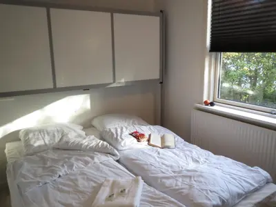 a bed with two pillows and a book on it at Danhostel Rebild in Skorping