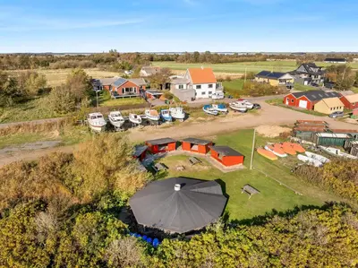 an aerial view of a house with an umbrella at Large Holiday Home With A View Of The Fjord in Thyholm