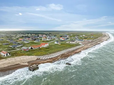 an aerial view of a town next to the ocean at Pool And Activity House With A Fantastic View Of The North Sea in Frøstrup