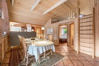 a kitchen and dining room with a table and chairs at Cozy And Spacious Holiday Home Near Torup Strand Close To The North Sea in Fjerritslev